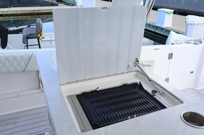  Yacht Photos Pics Outdoor grill on 2022 Regal 38 SAV boat, dockside view.
