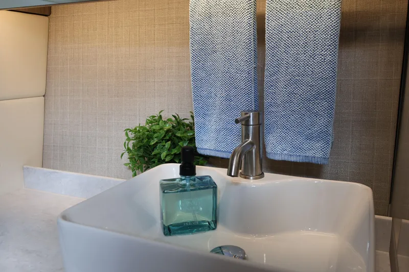  Yacht Photos Pics Modern bathroom sink with blue towels and soap, Regal 38 SAV 2022 model.