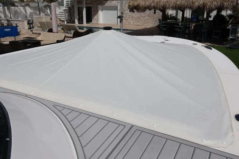  Yacht Photos Pics 2022 Regal 38 SAV boat with covered deck, poolside setting in background.