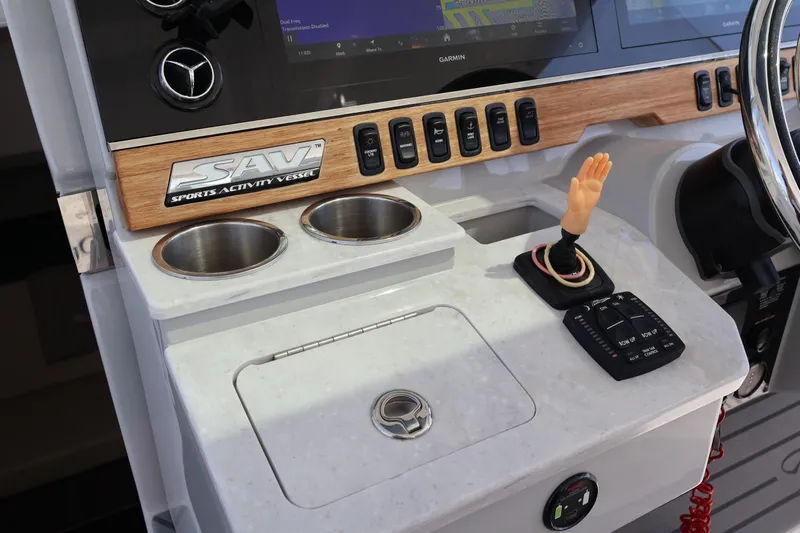  Yacht Photos Pics 2022 Regal 38 SAV dashboard with controls, cup holders, and unique hand decoration.