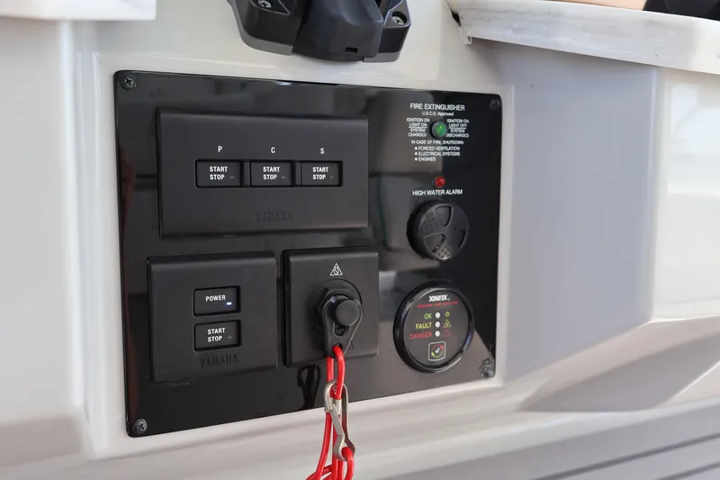  Yacht Photos Pics Control panel of 2022 Regal 38 SAV boat with start-stop buttons and safety indicators.