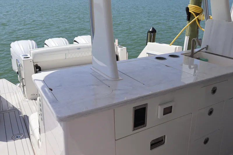  Yacht Photos Pics 2022 Regal 38 SAV boat interior with sleek countertop and dual outboard engines.