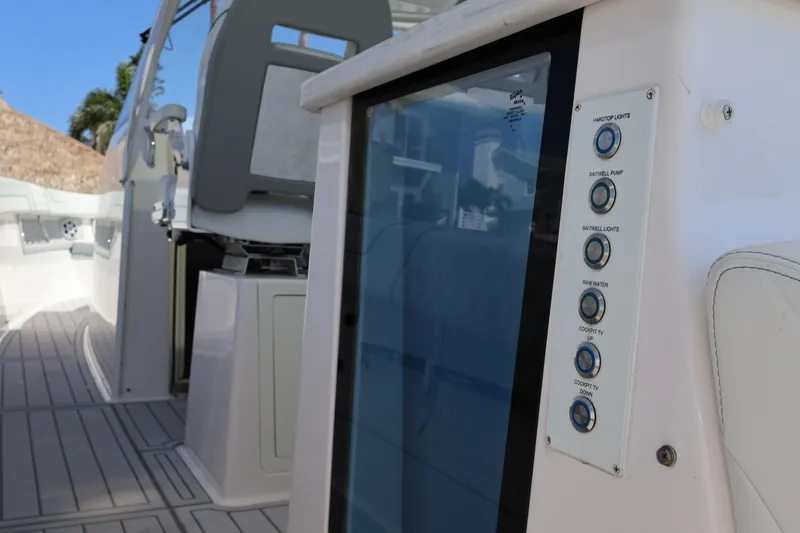  Yacht Photos Pics 2022 Regal 38 SAV boat interior with control panel and seating area.