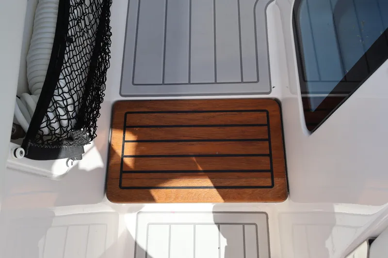  Yacht Photos Pics 2022 Regal 38 SAV boat deck with wooden panel and storage net.