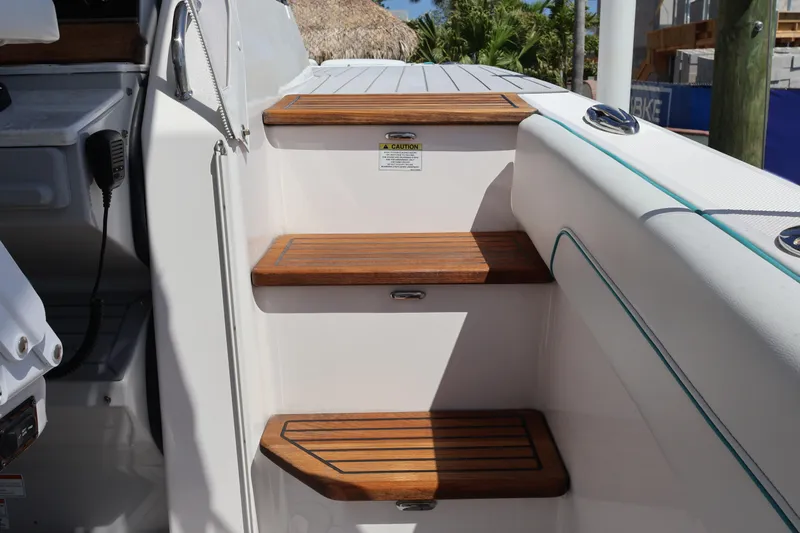  Yacht Photos Pics Wooden steps on a 2022 Regal 38 SAV boat, leading to the deck area.