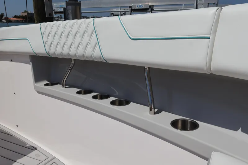  Yacht Photos Pics 2022 Regal 38 SAV boat interior with cushioned seating and built-in cup holders.