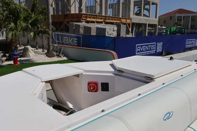  Yacht Photos Pics 2022 Regal 38 SAV boat docked near construction site with palm trees.