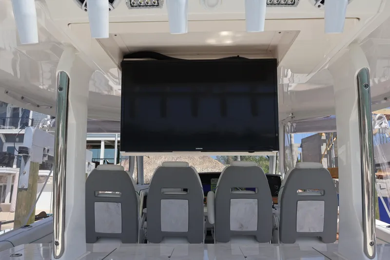 Yacht Photos Pics Interior of 2022 Regal 38 SAV boat with seating and a large screen display.