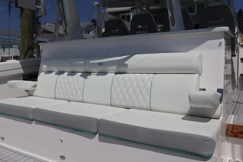  Yacht Photos Pics Luxurious seating on 2022 Regal 38 SAV boat with white upholstery and diamond stitching.