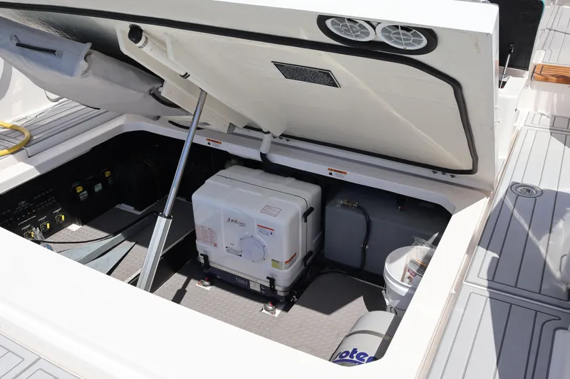  Yacht Photos Pics Open engine compartment of 2022 Regal 38 SAV boat, showcasing equipment and storage.