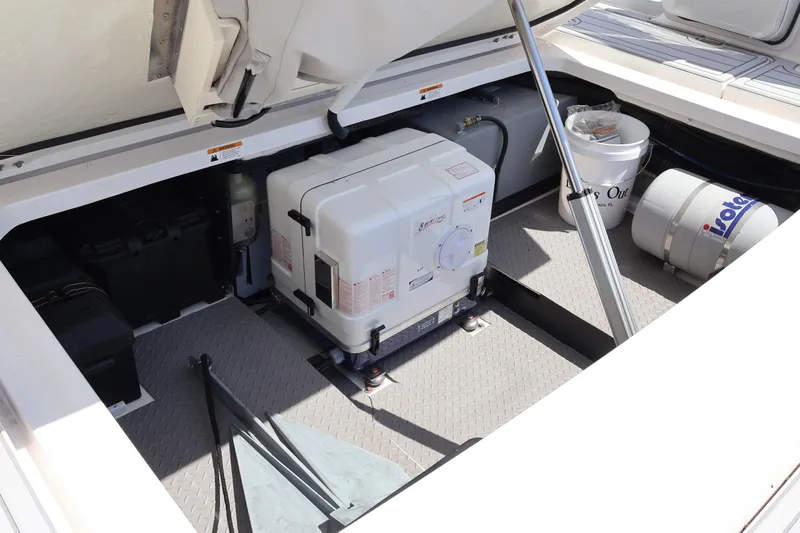  Yacht Photos Pics 2022 Regal 38 SAV engine compartment with generator and storage items.