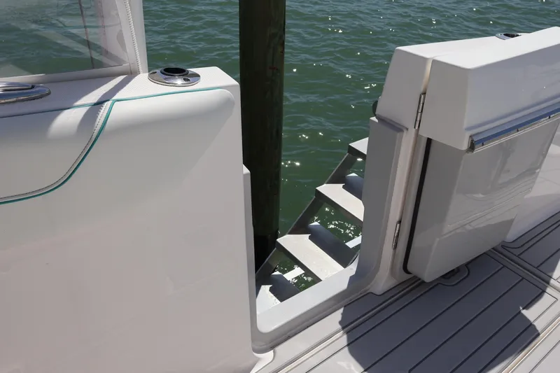  Yacht Photos Pics 2022 Regal 38 SAV boat with open side door and steps leading to water.
