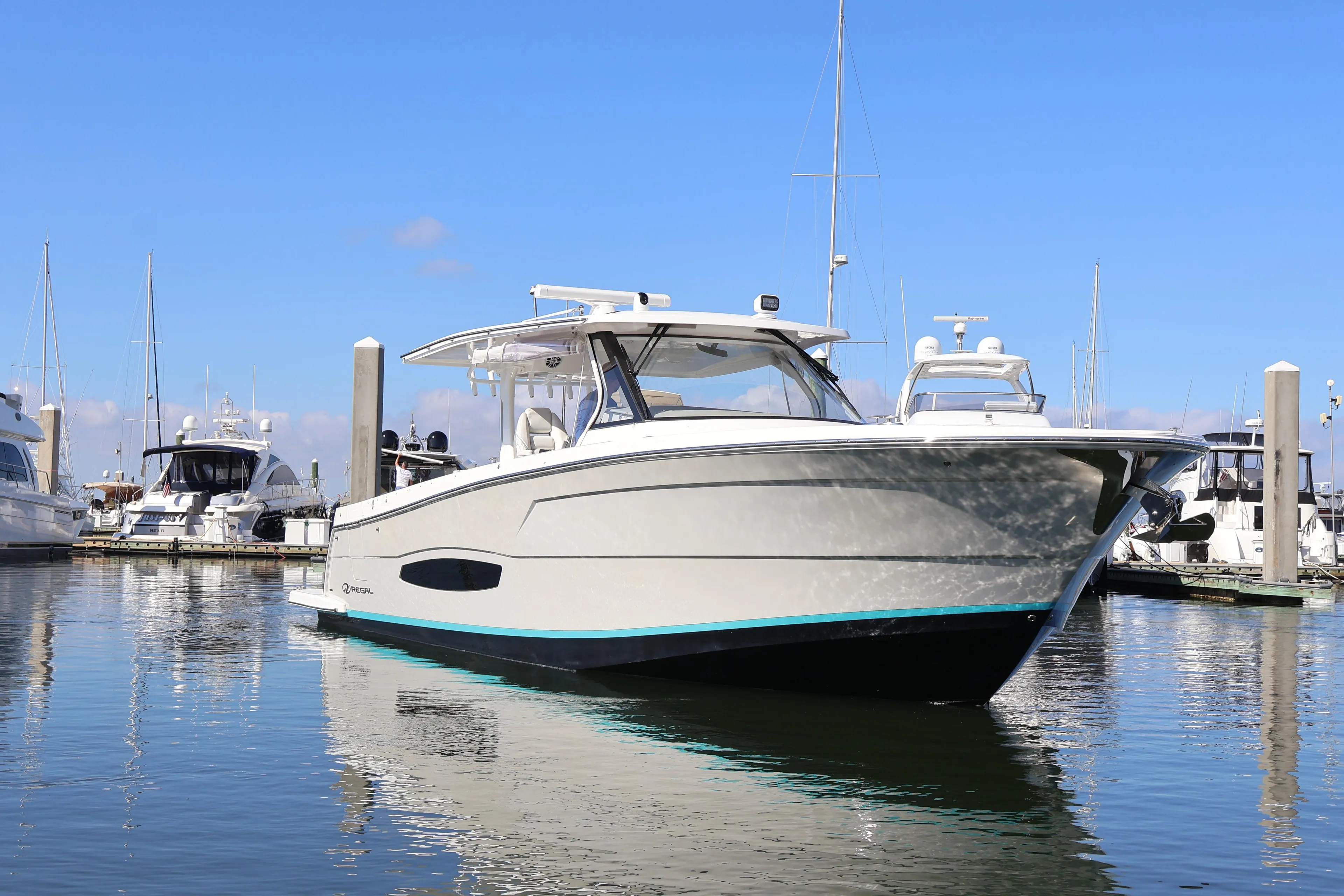 2022 Regal 38 SAV boat docked in marina, clear blue sky background.