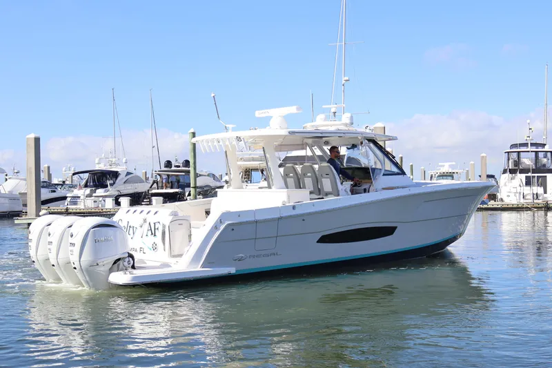  Yacht Photos Pics 2022 Regal 38 SAV boat docked in marina with triple Yamaha outboard engines.
