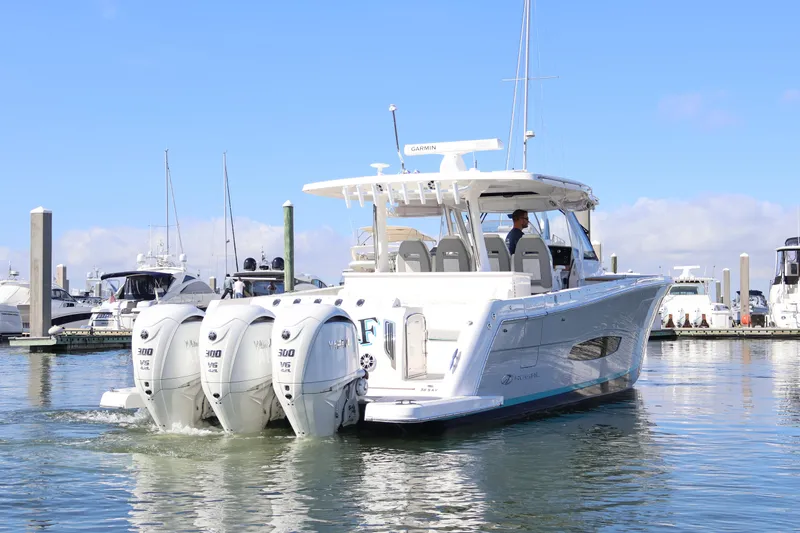  Yacht Photos Pics 2022 Regal 38 SAV boat with triple Yamaha engines docked in marina.