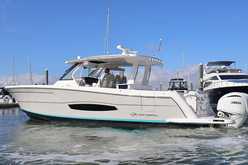  Yacht Photos Pics 2022 Regal 38 SAV boat with Yamaha engines docked in a marina.