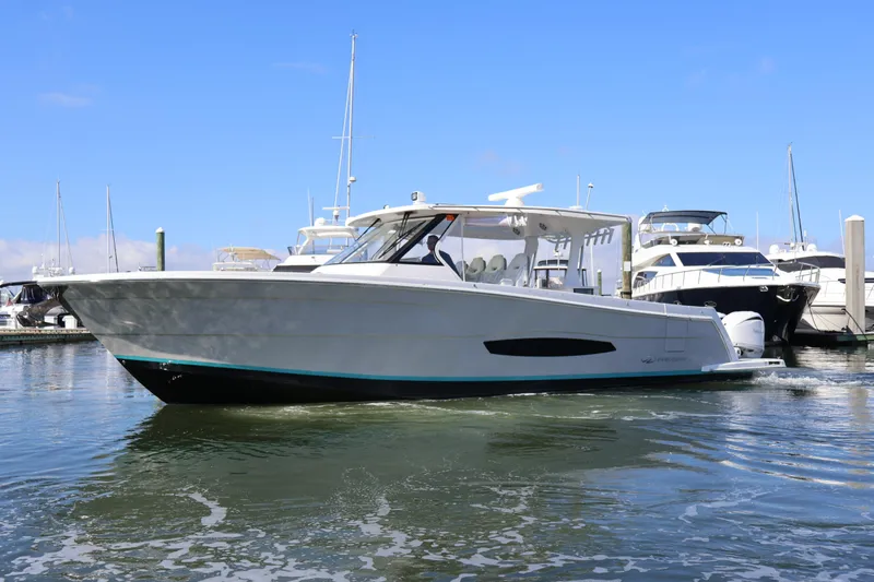 Yacht Photos Pics 2022 Regal 38 SAV boat docked in marina, clear sky background.