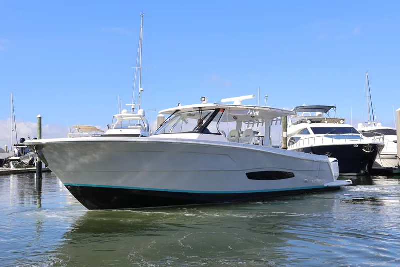  Yacht Photos Pics 2022 Regal 38 SAV boat docked in marina under clear blue sky.