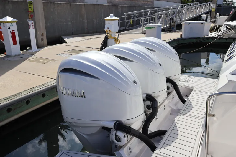  Yacht Photos Pics 2022 Regal 38 SAV boat with triple Yamaha outboard engines docked at marina.