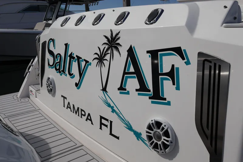  Yacht Photos Pics 2022 Regal 38 SAV boat with "Salty AF" and "Tampa FL" text on the side.