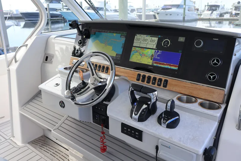  Yacht Photos Pics 2022 Regal 38 SAV boat helm with advanced navigation displays and controls at marina.