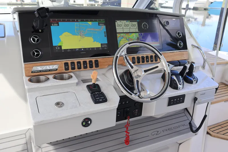  Yacht Photos Pics 2022 Regal 38 SAV boat dashboard with navigation screens and steering wheel.