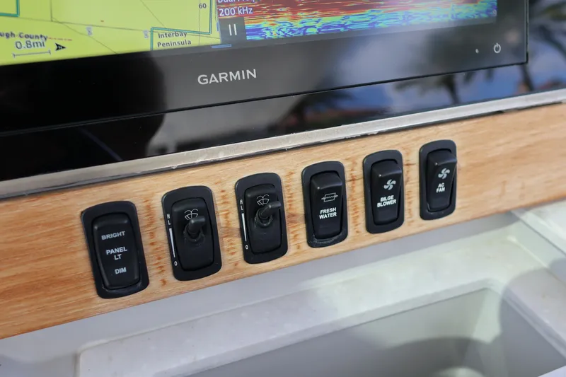  Yacht Photos Pics Control panel of 2022 Regal 38 SAV boat with Garmin display and switches.