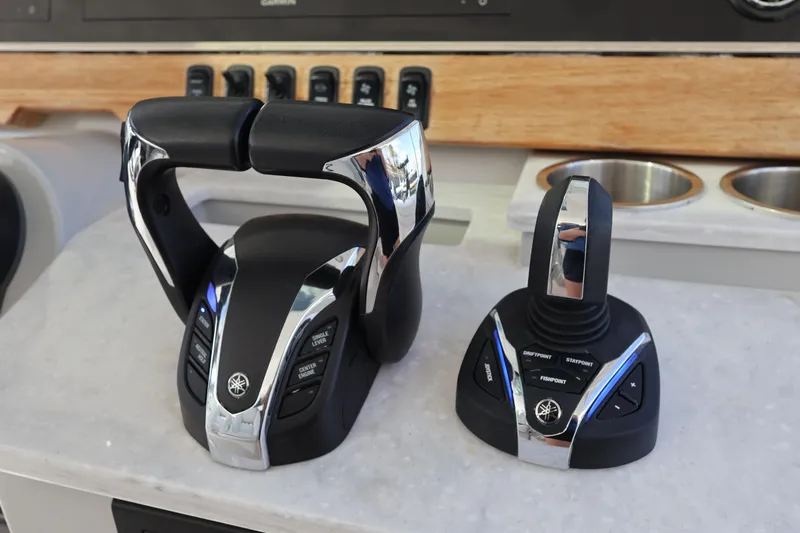  Yacht Photos Pics 2022 Regal 38 SAV boat controls with chrome accents on a white console.