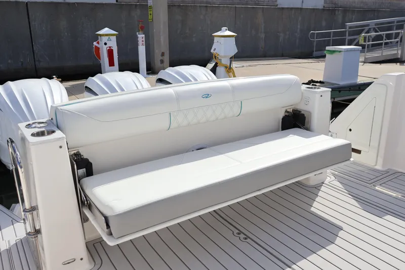  Yacht Photos Pics 2022 Regal 38 SAV boat with white seating and triple outboard engines.