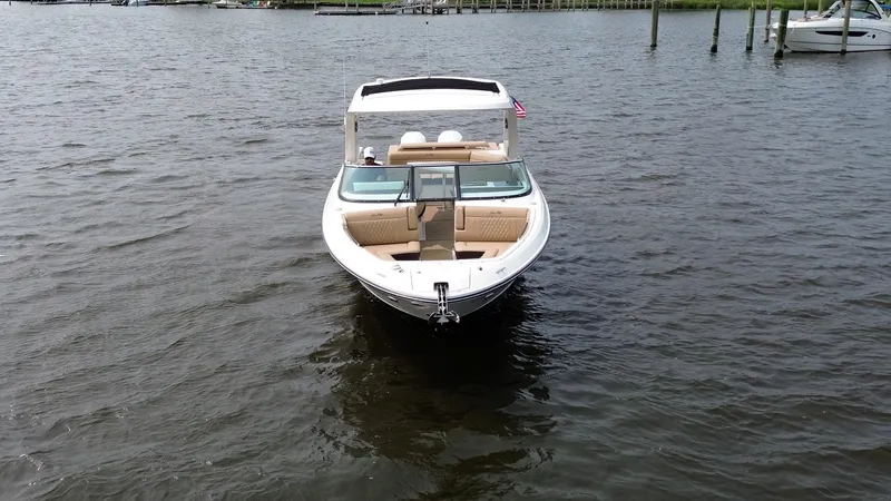  Yacht Photos Pics 2023 Sea Ray SLX 310 boat on calm water, front view.