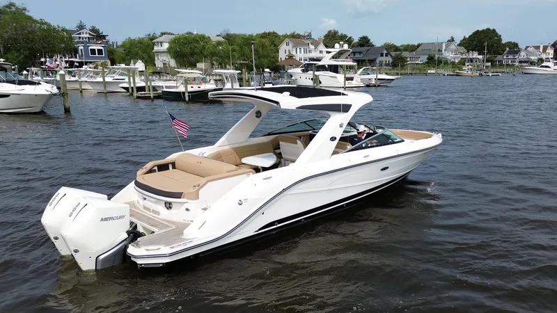  Yacht Photos Pics 2023 Sea Ray SLX 310 boat on water, featuring sleek design and spacious seating.