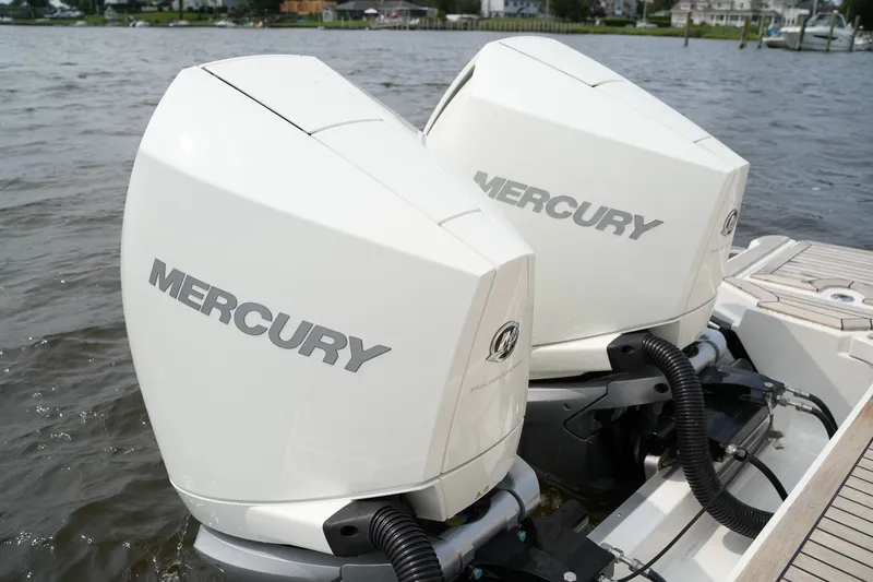  Yacht Photos Pics Twin Mercury outboard engines on a 2023 Sea Ray SLX 310 boat, docked on a calm lake.