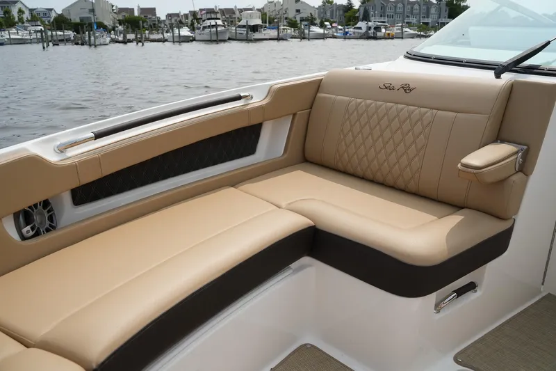  Yacht Photos Pics 2023 Sea Ray SLX 310 boat interior with tan leather seating, dockside view.
