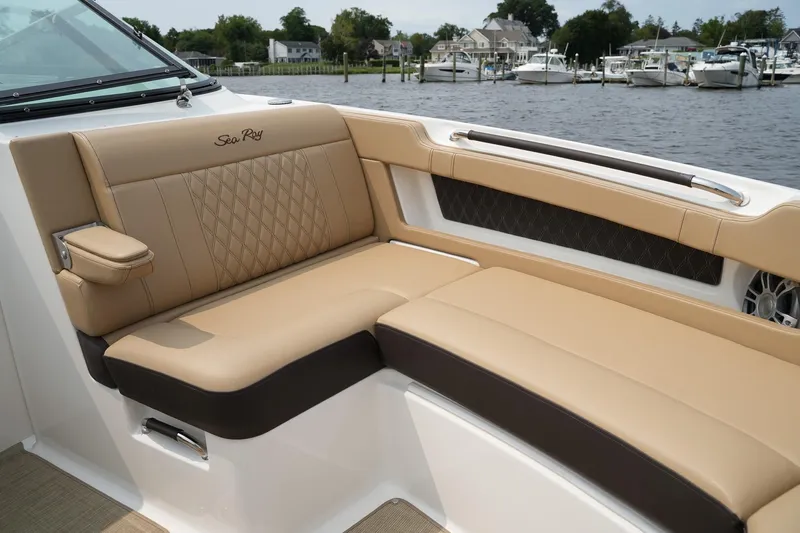  Yacht Photos Pics 2023 Sea Ray SLX 310 boat interior with tan leather seating by the water.