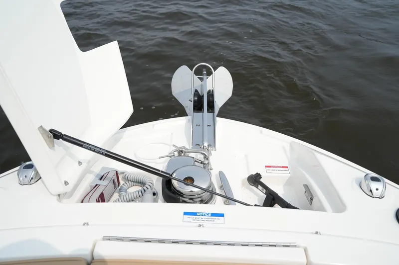  Yacht Photos Pics 2023 Sea Ray SLX 310 boat anchor compartment with open hatch on water.