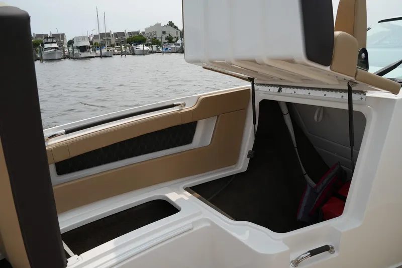  Yacht Photos Pics 2023 Sea Ray SLX 310 boat storage compartment open by the water.