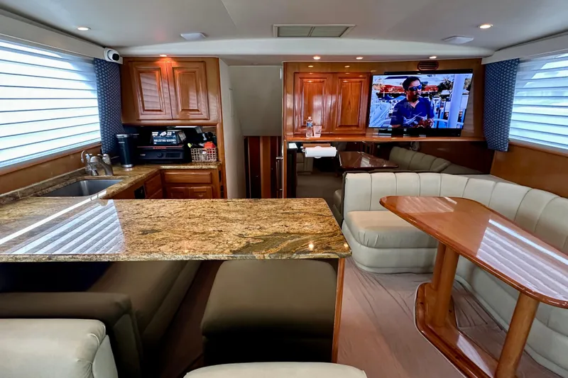 Dock Fee Yacht Photos Pics Luxurious interior of a 1998 Viking 50 Convertible yacht with granite countertops and plush seating.