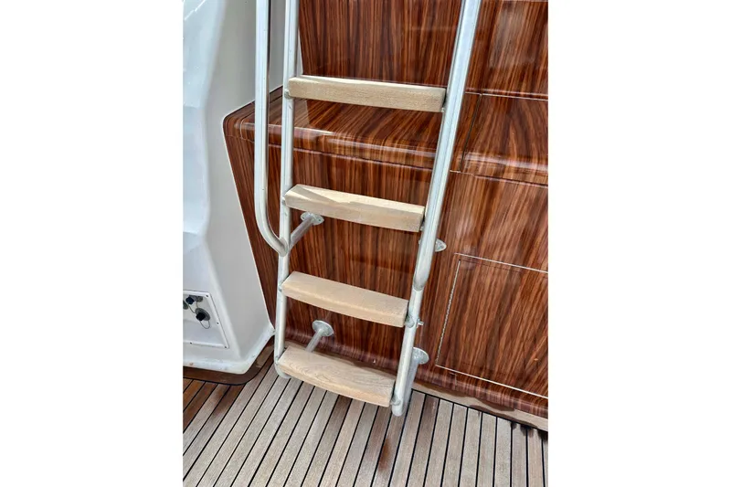 Dock Fee Yacht Photos Pics Ladder on 1998 Viking 50 Convertible yacht with wooden steps and sleek design.