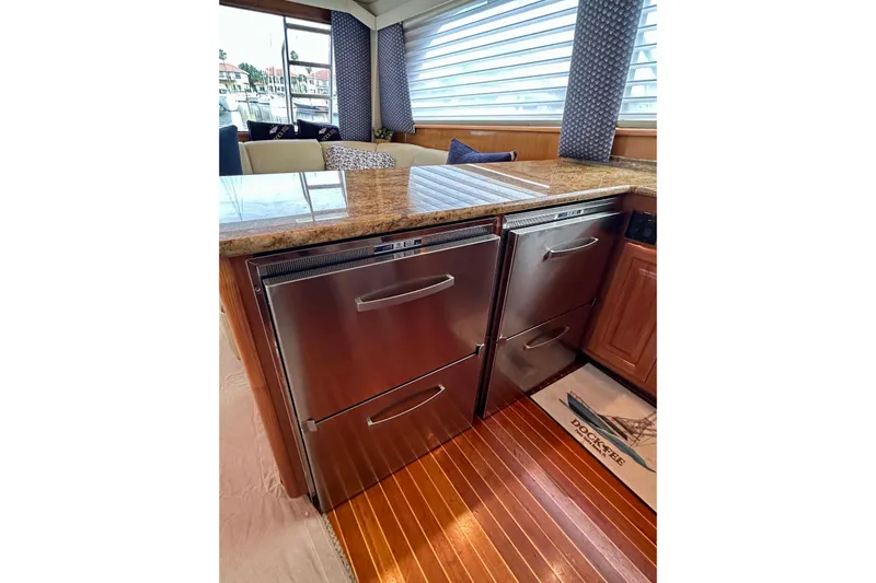 Dock Fee Yacht Photos Pics Luxurious kitchen interior of 1998 Viking 50 Convertible yacht with stainless steel appliances.