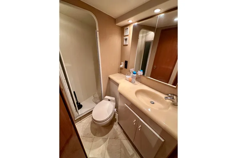 Dock Fee Yacht Photos Pics Bathroom in 1998 Viking 50 Convertible yacht with shower, toilet, and sink.
