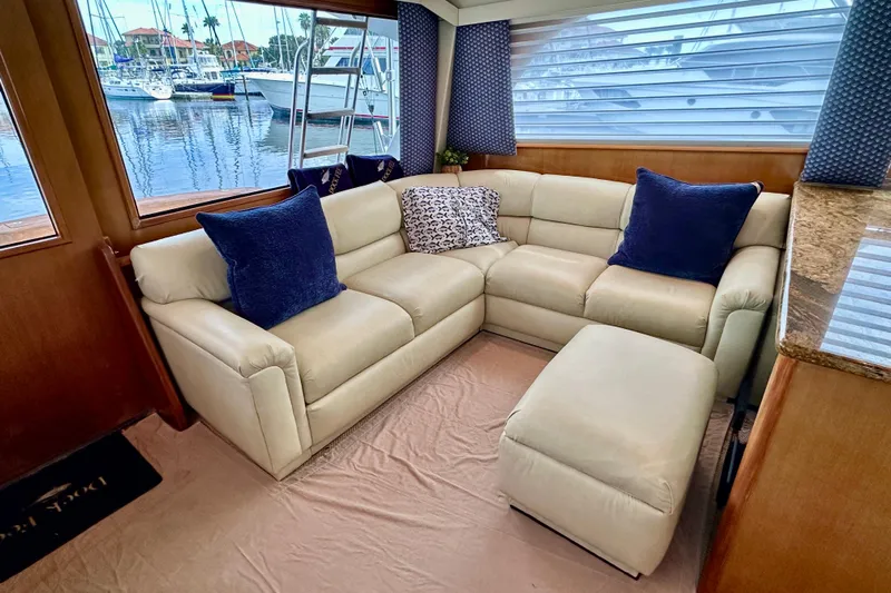 Dock Fee Yacht Photos Pics Luxurious interior of 1998 Viking 50 Convertible yacht with cream leather seating.