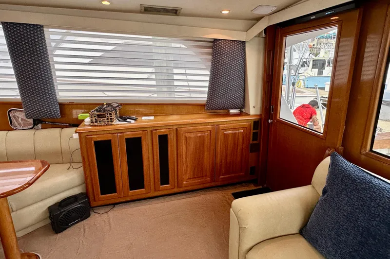 Dock Fee Yacht Photos Pics Interior of 1998 Viking 50 Convertible yacht with wooden cabinetry and seating.