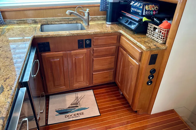 Dock Fee Yacht Photos Pics 1998 Viking 50 Convertible yacht kitchen with granite countertops and wooden cabinetry.