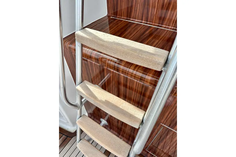 Dock Fee Yacht Photos Pics Wooden ladder steps on a 1998 Viking 50 Convertible yacht with polished wood background.