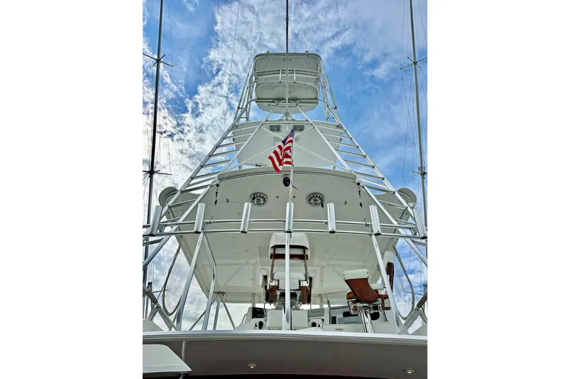Dock Fee Yacht Photos Pics 1998 Viking 50 Convertible yacht with tower against a blue sky.