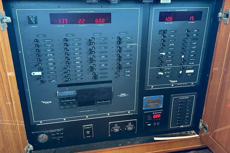 Dock Fee Yacht Photos Pics Electrical control panel of a 1998 Viking 50 Convertible boat, featuring various switches and meters.