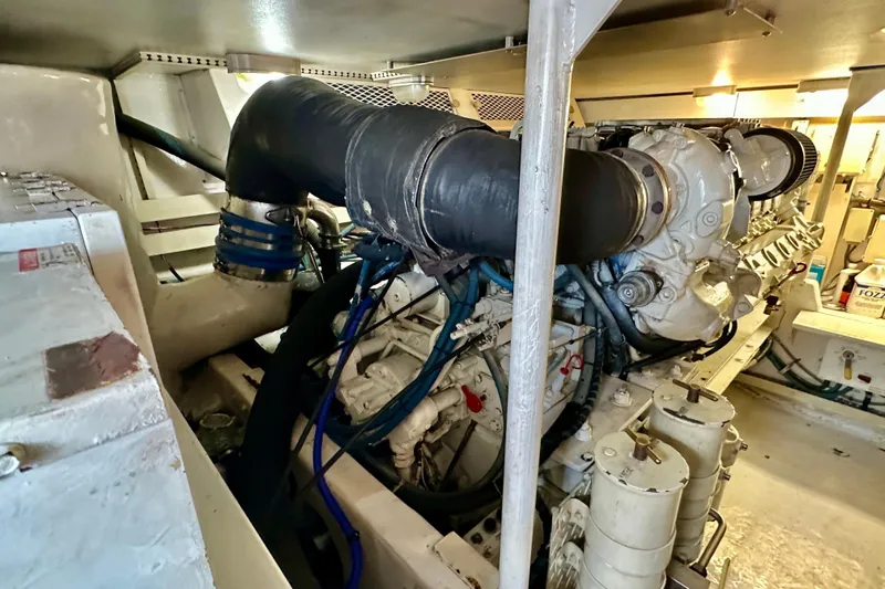 Dock Fee Yacht Photos Pics Engine room of a 1998 Viking 50 Convertible yacht, showcasing complex machinery.