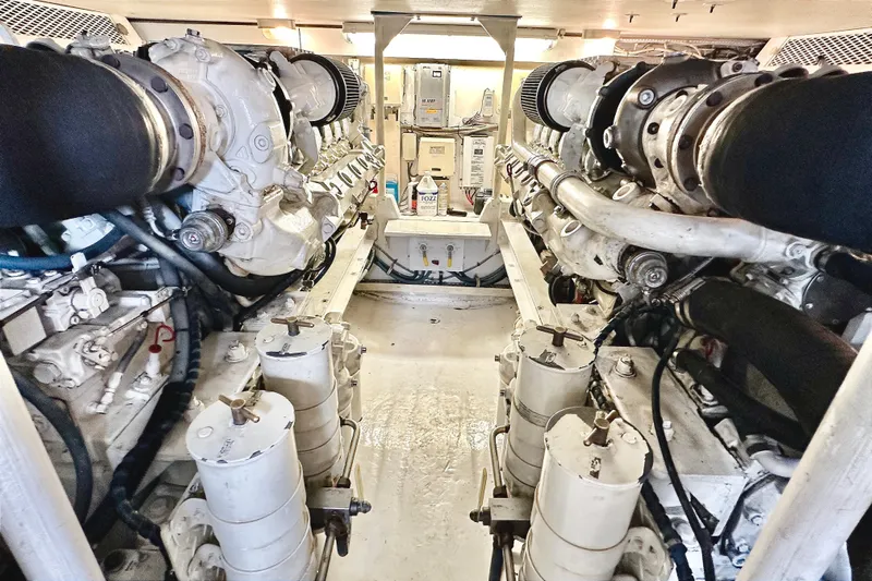 Dock Fee Yacht Photos Pics Engine room of a 1998 Viking 50 Convertible yacht, showcasing dual engines and mechanical components.