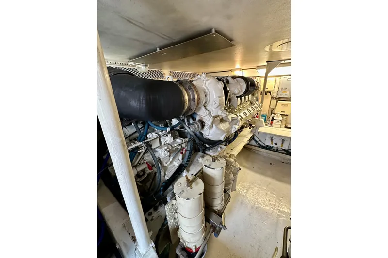 Dock Fee Yacht Photos Pics Engine room of a 1998 Viking 50 Convertible yacht, showcasing machinery and components.