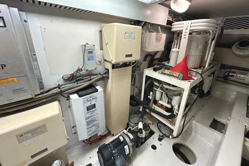 Dock Fee Yacht Photos Pics Engine room of a 1998 Viking 50 Convertible yacht, showcasing mechanical equipment and wiring.